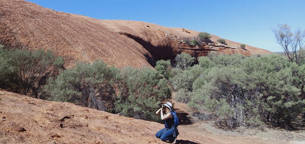 A woman photographing Walga Rock