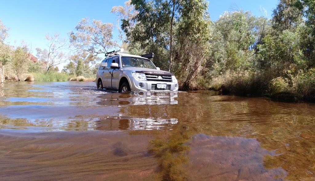 Car driving through river