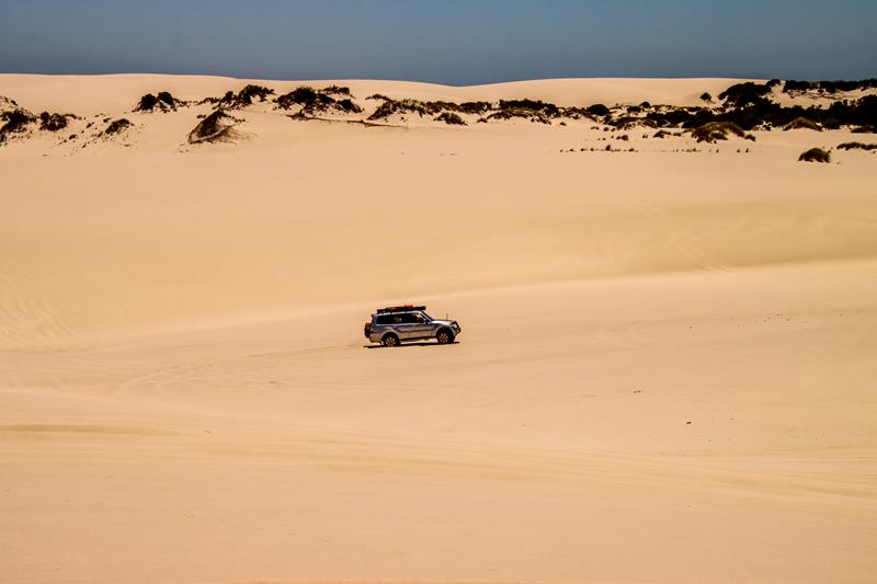 Vehicle driving through dunes