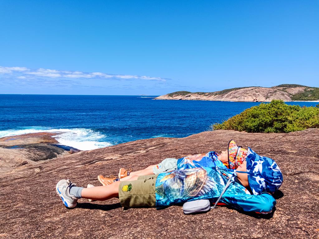 Kids lying on a rock at Thistle Cove