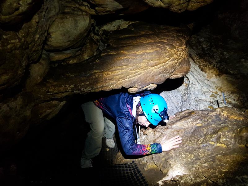 Squeezing between rocks at Giants Cave in Leeuwin Naturaliste National Park