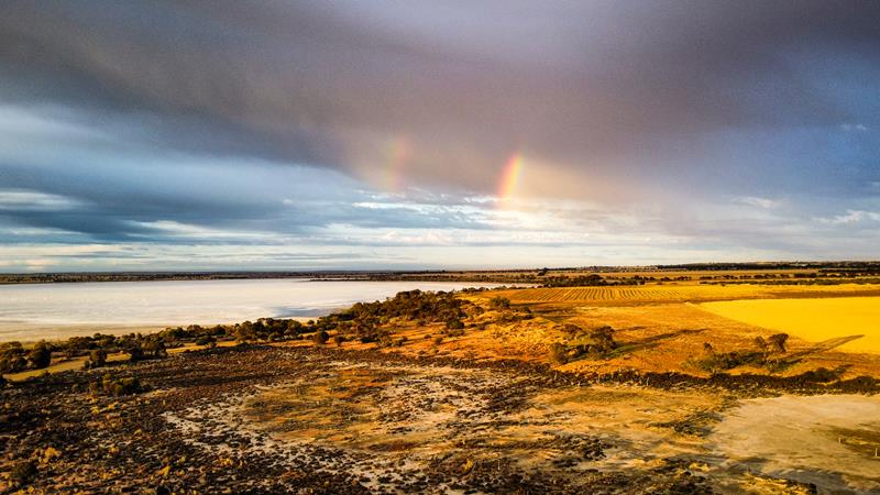 Stormy clouds and rainbow over Baandee Lake