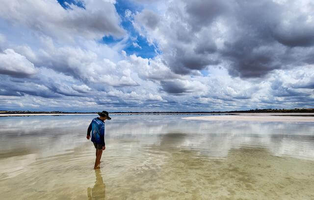 A boy walking in Lake Dumbleyung